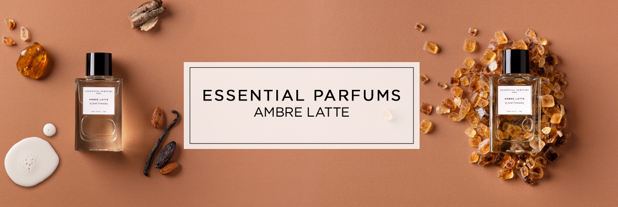 Bannerbild für das Parfum „Ambre Latte“ von Essential Parfums mit zwei Flakons, umgeben von bernsteinfarbenen Kristallen, Vanilleschoten und warmen Brauntönen.