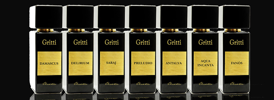 Werbebild mit sieben luxuriösen Parfumflakons der Marke Gritti, nebeneinander aufgereiht vor schwarzem Hintergrund. Die Flakons sind schwarz mit goldenen Etiketten, die jeweils den Namen des Duftes tragen: Damascus, Delirium, Saraj, Preludio, Antalya, Aqua Incanta und Fanòs. Unter jedem Etikett steht in kursiver Schrift 'Gritti Collection'.