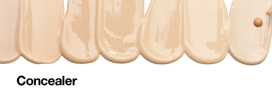 Mehrere nebeneinander aufgetragene Concealer-Texturen in verschiedenen hellen Hauttönen, dazu der Schriftzug 'Concealer'.