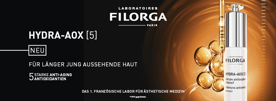 Werbeanzeige für das Filorga HYDRA-AOX [5] Serum. Links steht: 'Neu – Für länger jung aussehende Haut – 5 starke Anti-Aging-Antioxidantien'. Rechts ist das Produkt vor goldbraunem Hintergrund mit leuchtenden Ölperlen und Pipette zu sehen.